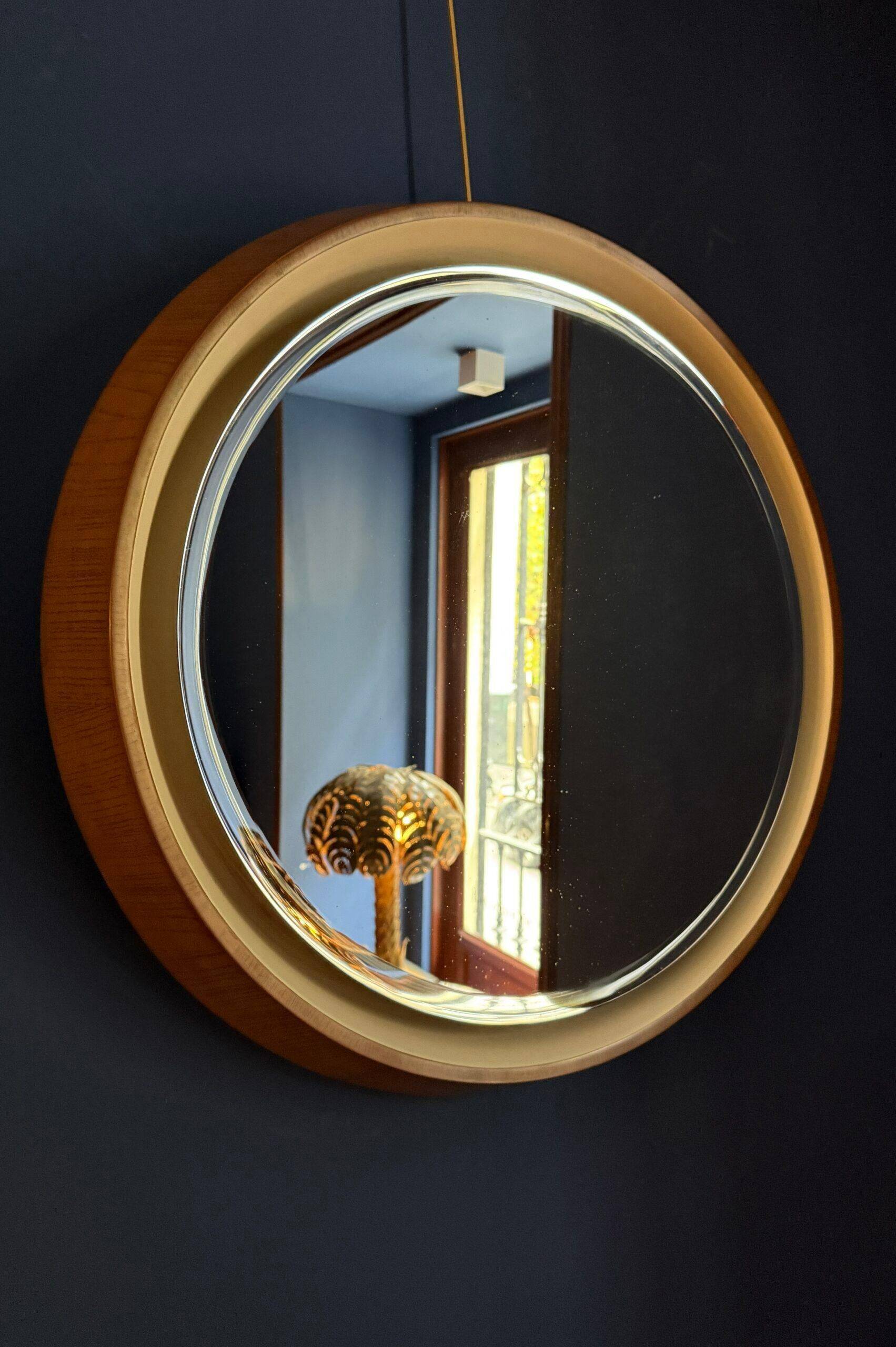 Backlit mirror designed by Gio Ponti in wood and lacquer. Italy, 1970s.