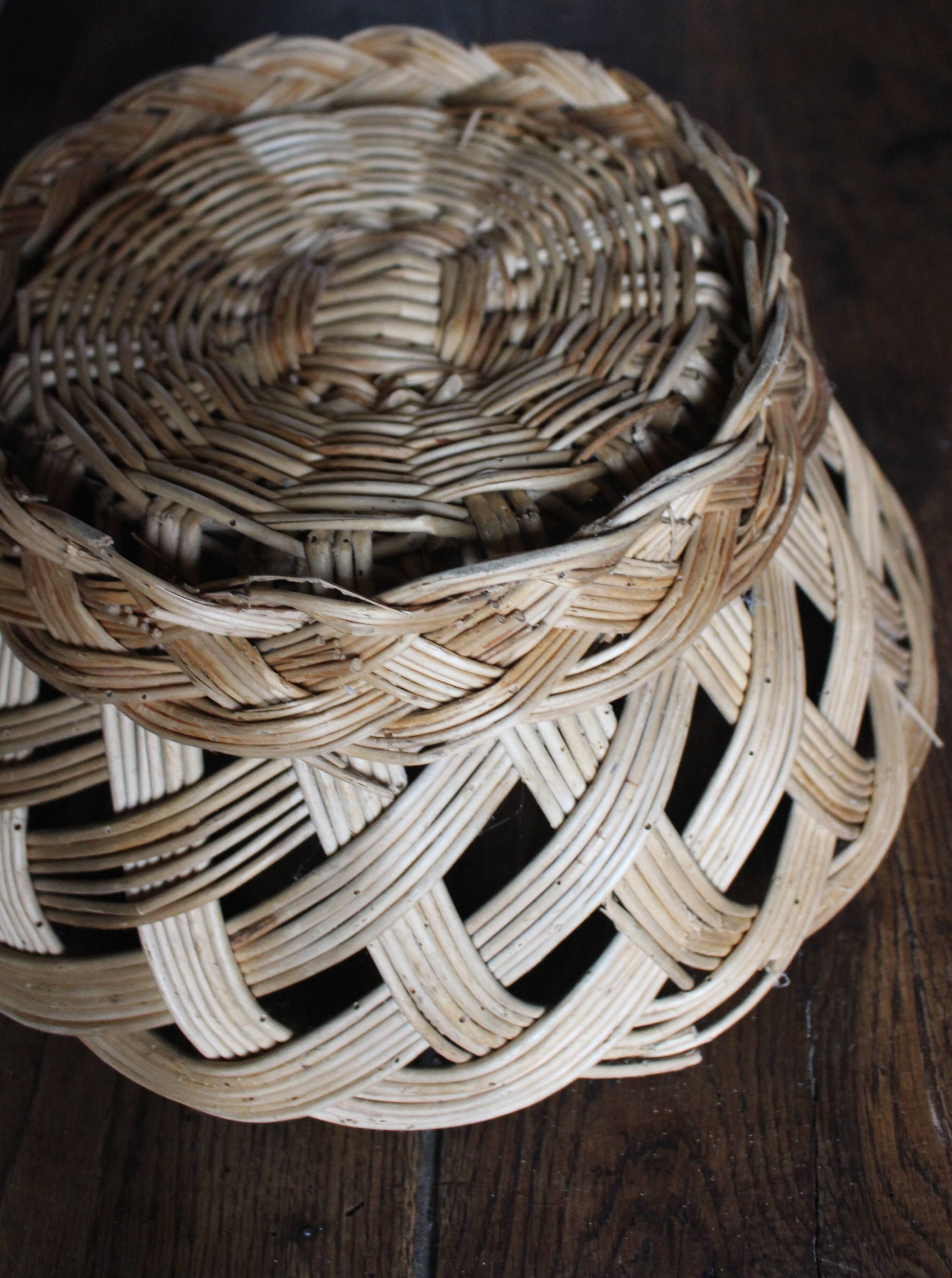 Large vintage twisted wicker basket on a stand