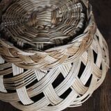 Large vintage twisted wicker basket on a stand