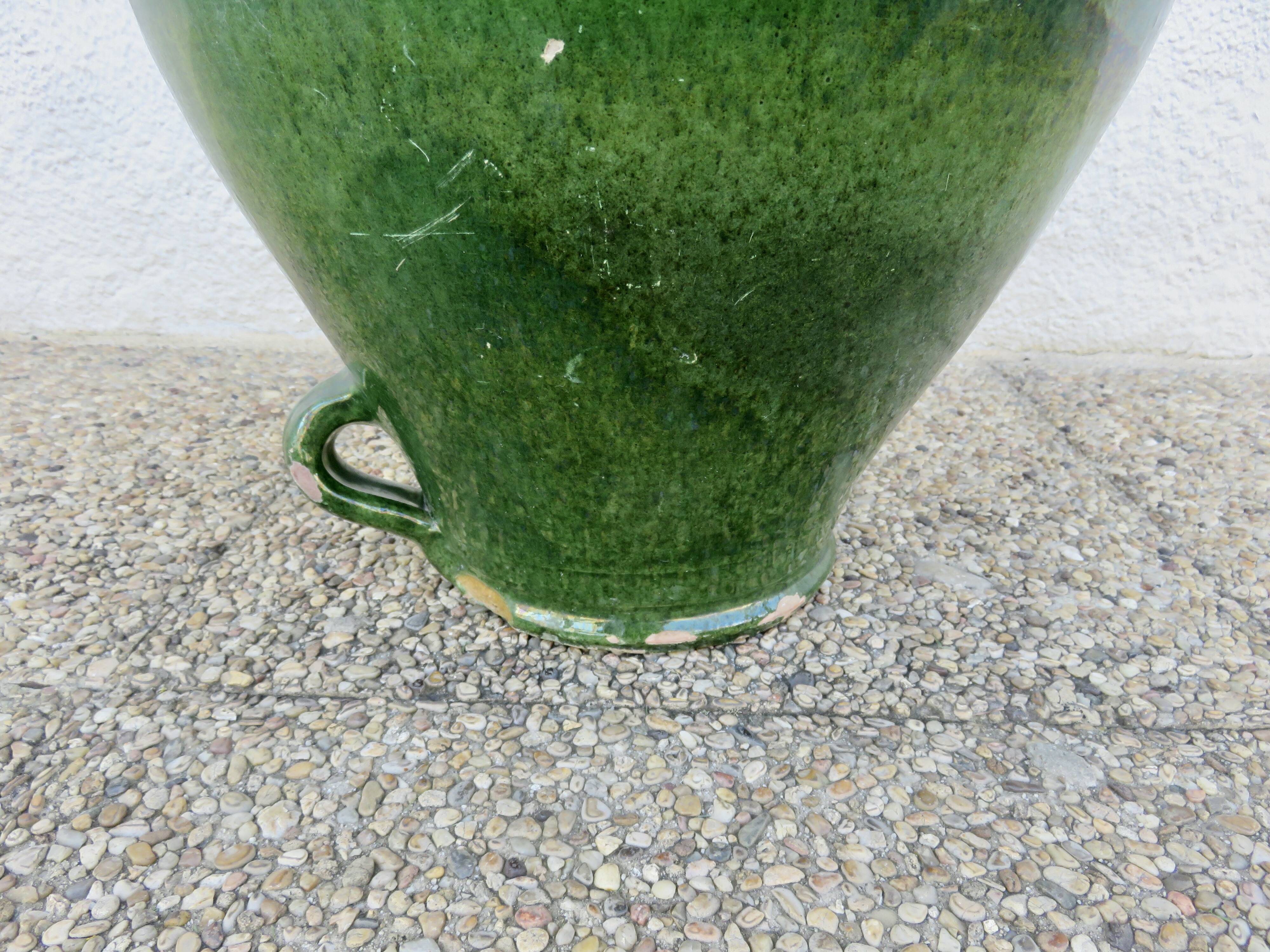 Antique glazed green terracotta oil jar, late 19th century.