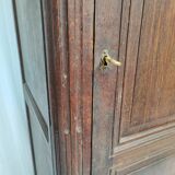 Bonnetière man standing cabinet a door