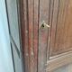 Bonnetière man standing cabinet a door