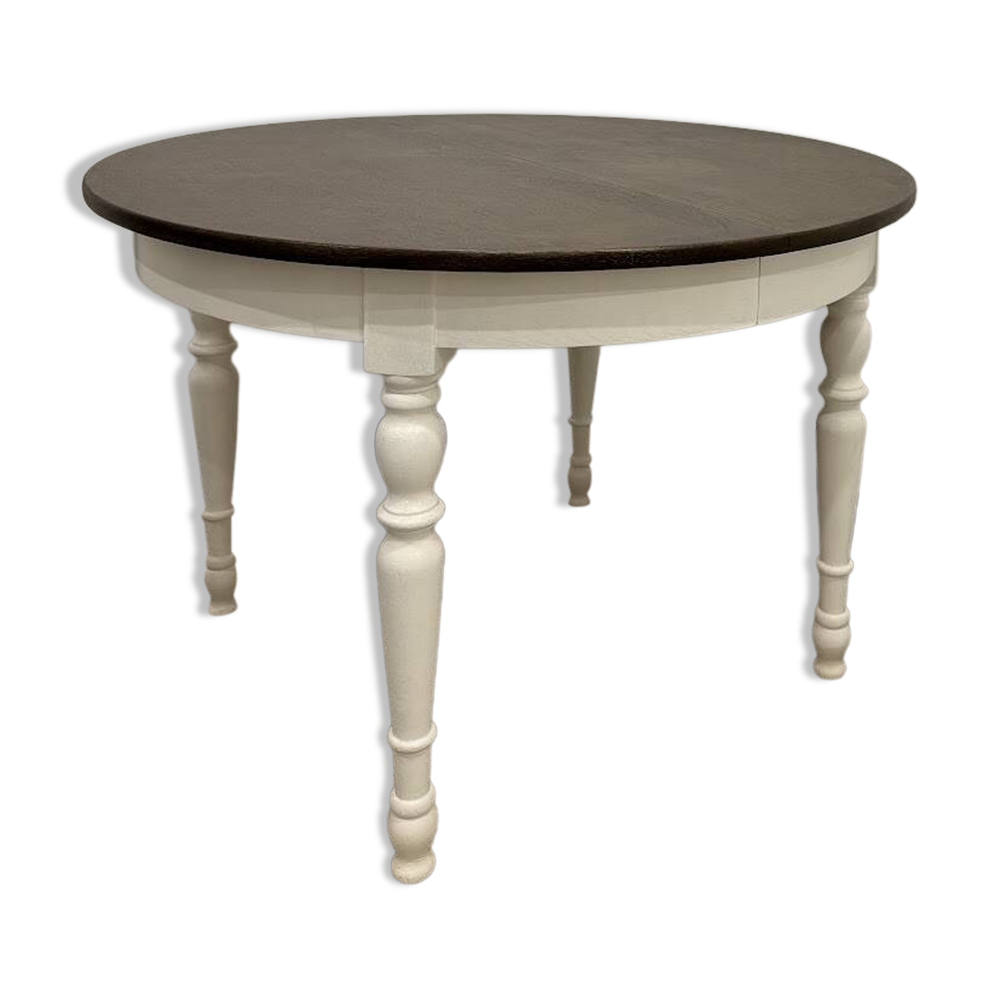 Restored solid wood round table with integrated extensions.