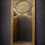 Very large mirror with mouldings, richly carved and gilded, in the Louis XVI style.