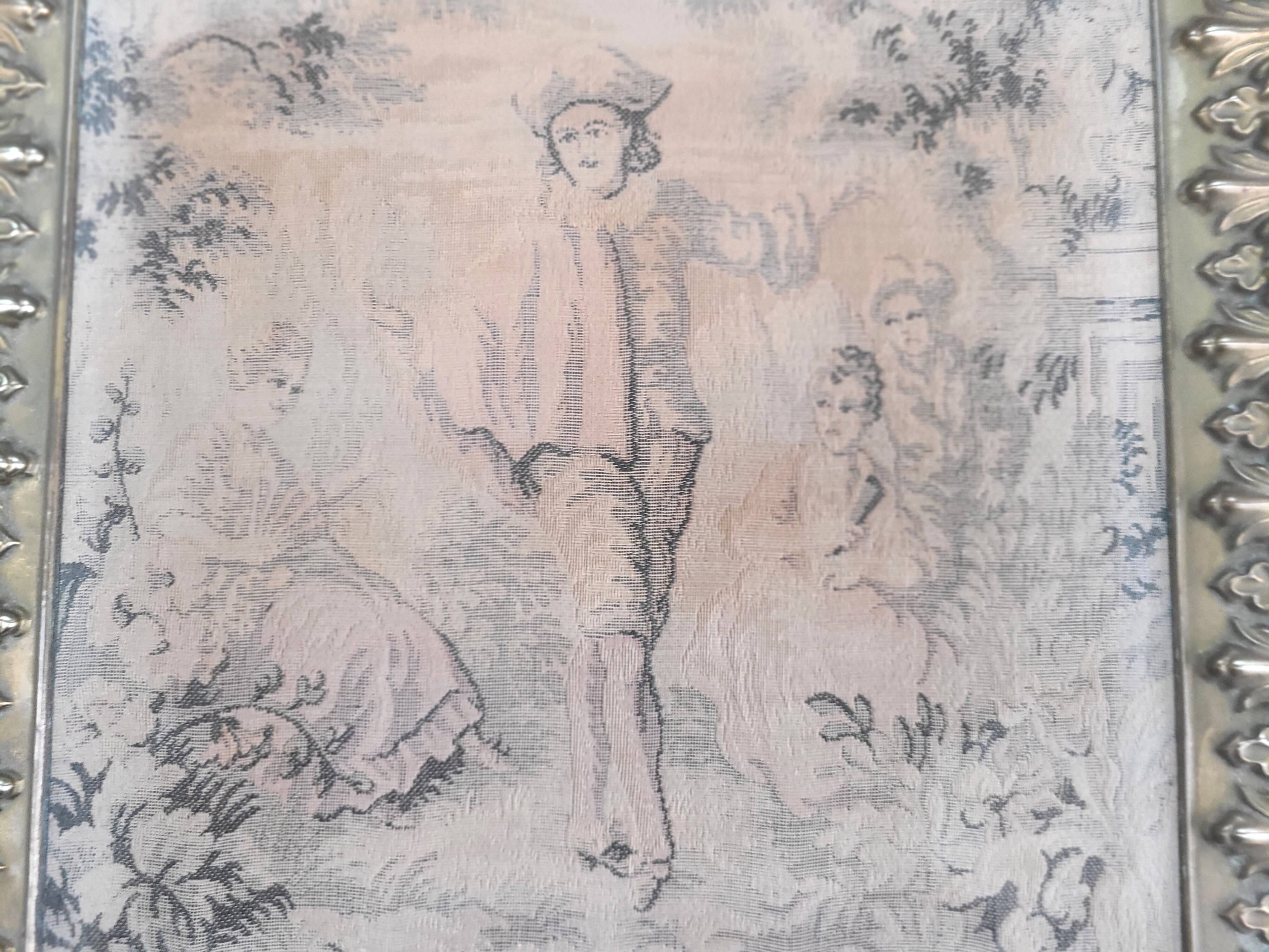 Antique tapestries framed in repoussé brass.