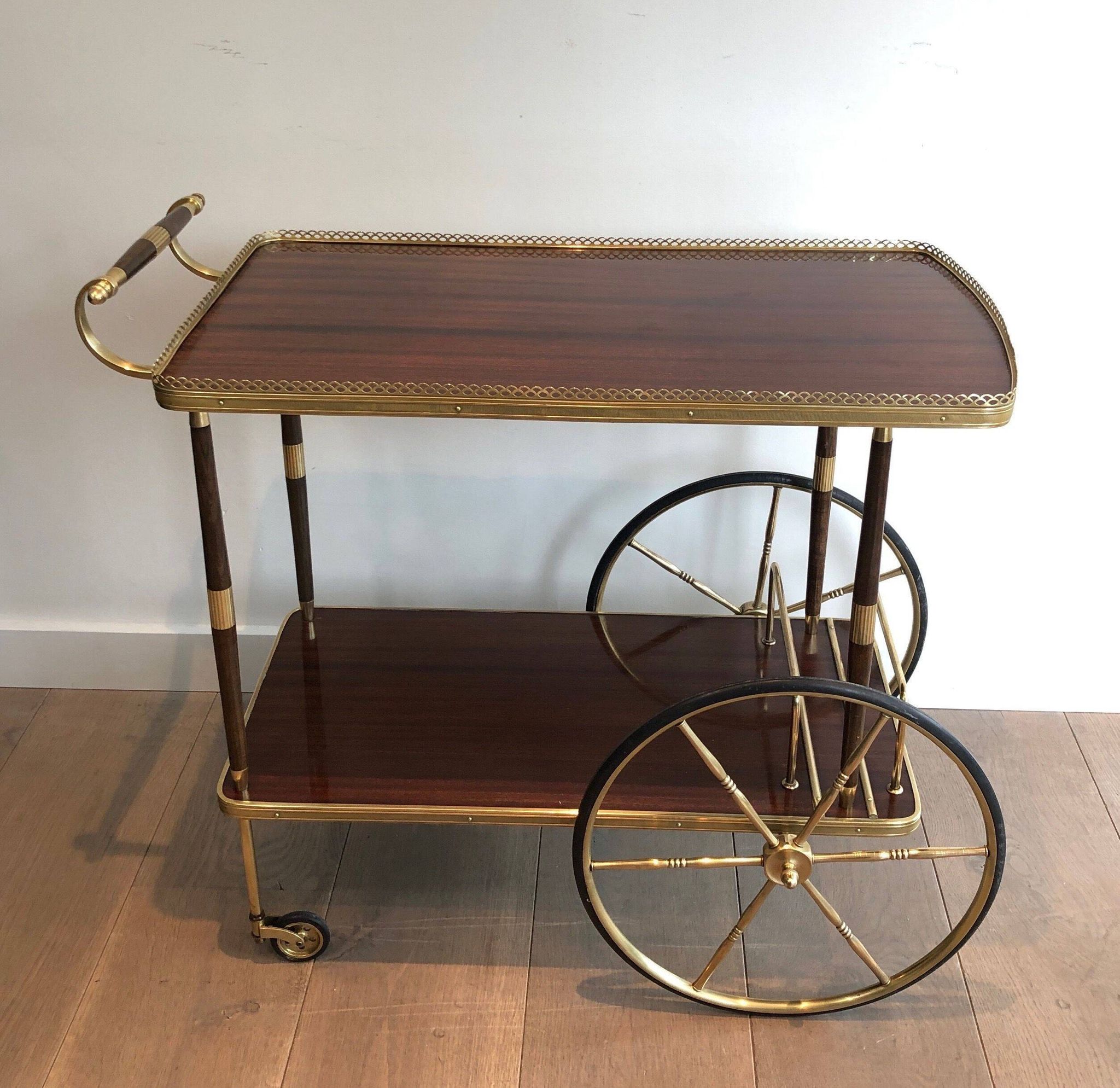 Mahogany and brass rolling table in the style of Maison Jansen.