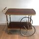 Mahogany and brass rolling table in the style of Maison Jansen.