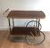 Mahogany and brass rolling table in the style of Maison Jansen.