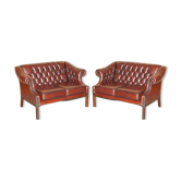 Restored leather tufted Chesterfield sofa pair Harrods London