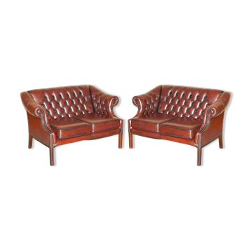 Restored leather tufted Chesterfield sofa pair Harrods London