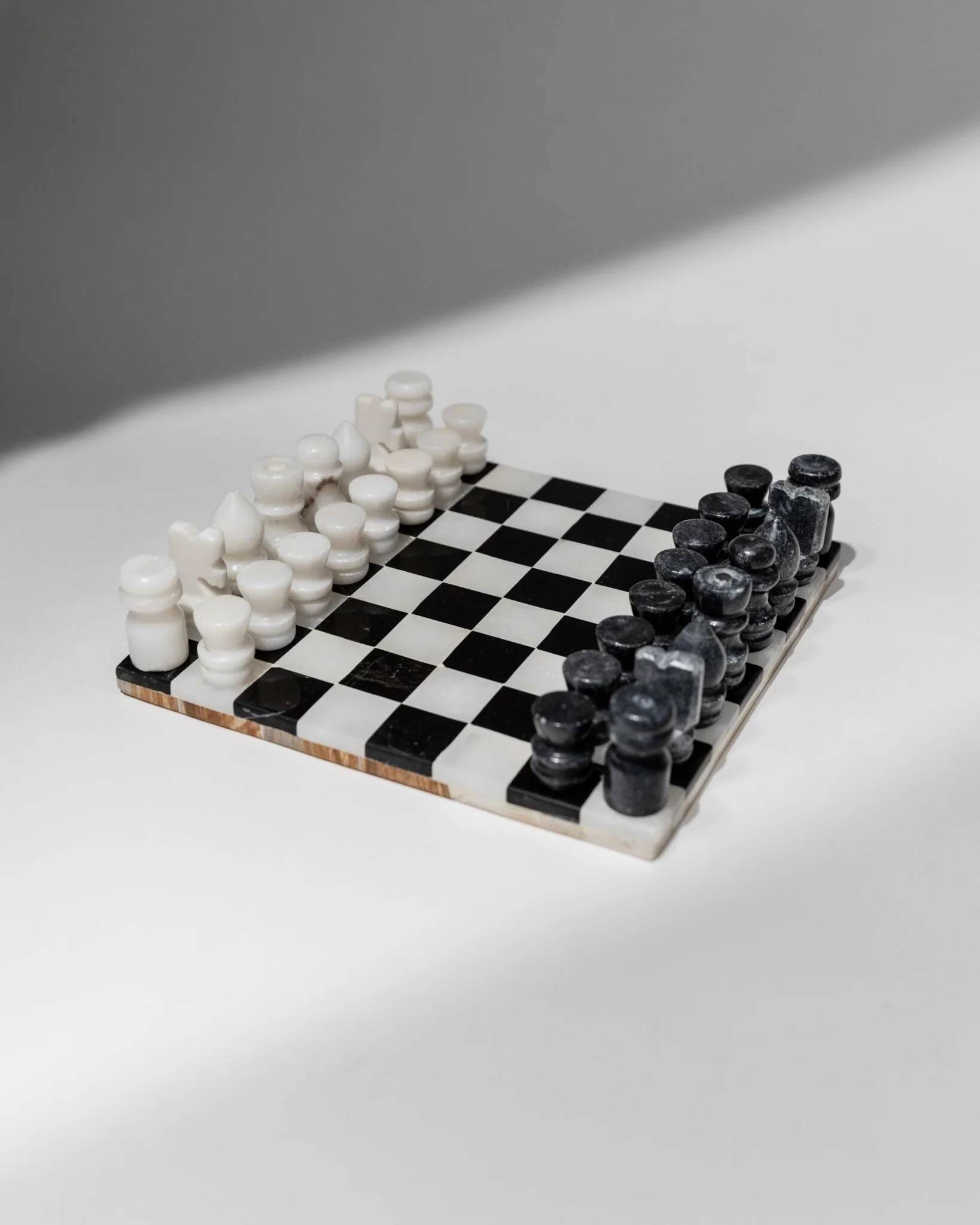 Vintage black-and-white marble chessboard with matching marble pieces, Italian 1960s design, sculptural centerpiece