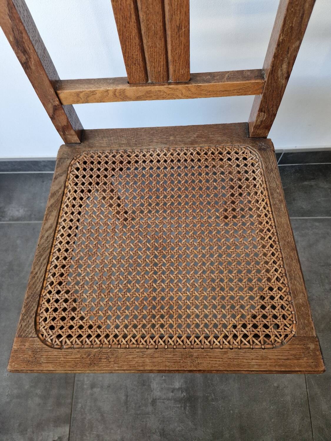 Wooden and cane chair. Carved wooden chair with cane seat.