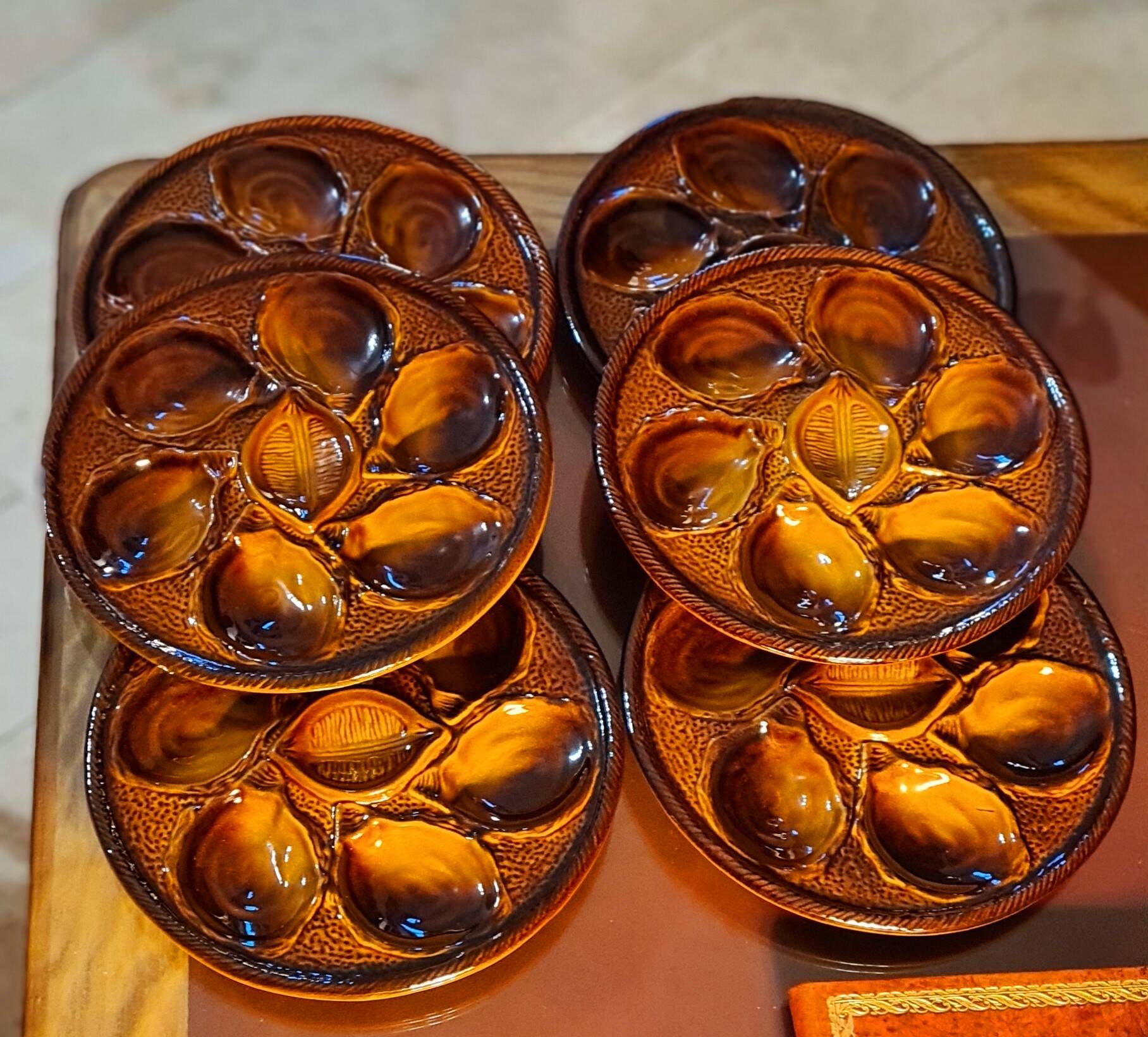 Six oyster plates signed Saint Clément