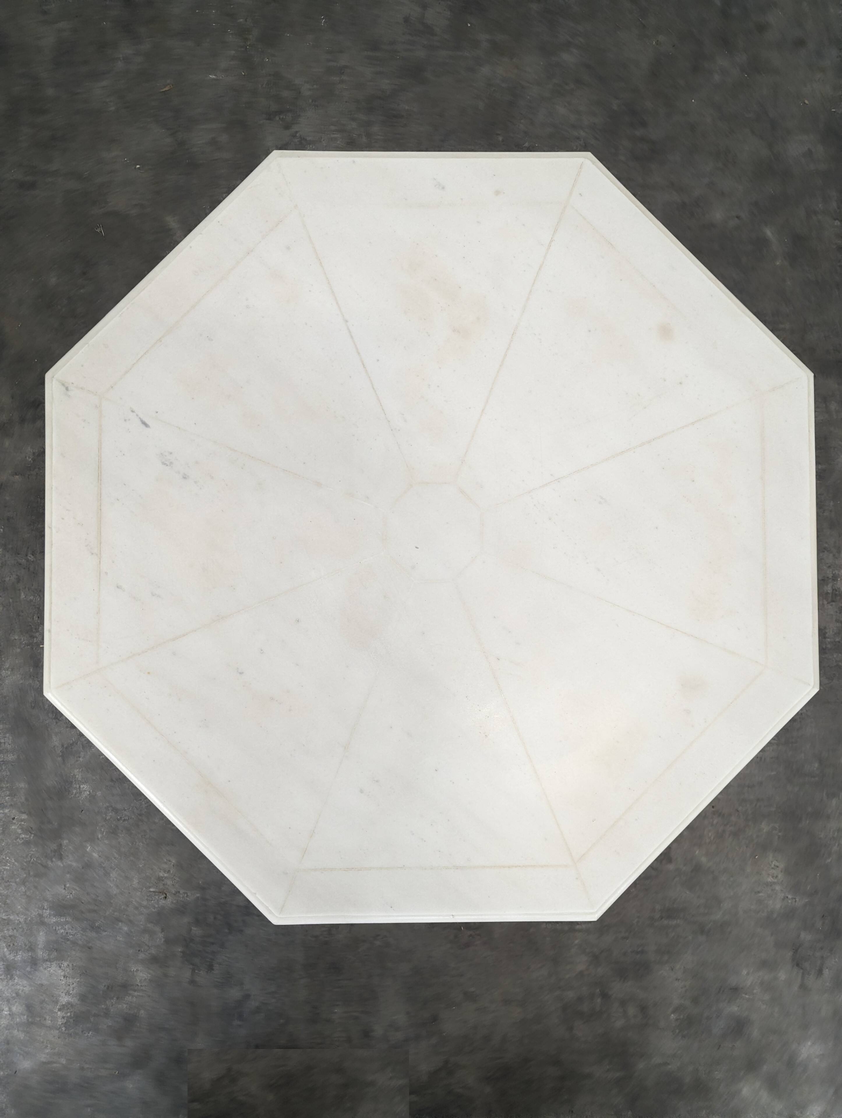 1940s octagonal coffee table with a marble top.