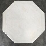 1940s octagonal coffee table with a marble top.