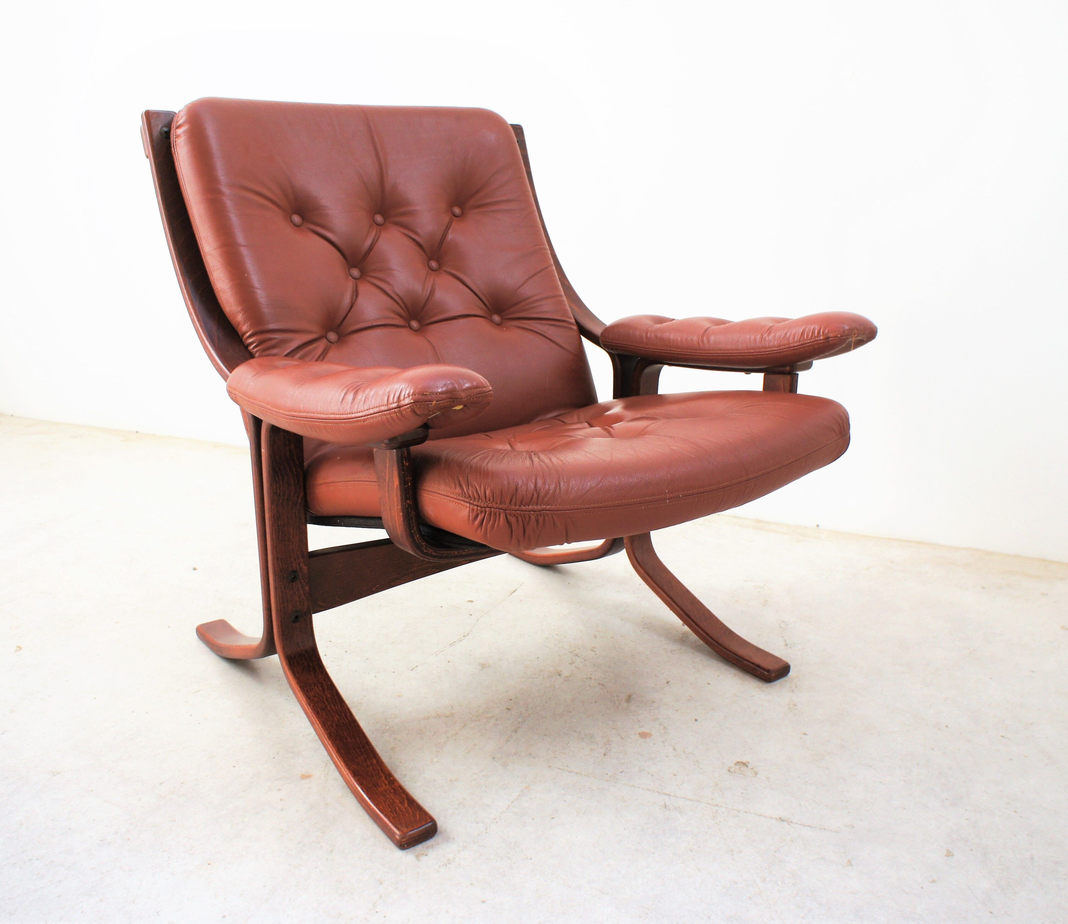 Scandinavian armchair made of wood and cognac leather