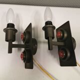 A set of Vitrika Denmark, cast iron wall lights with red details.