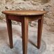 Antique round side table with oak legs and a pine top, circa 1900.