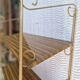 Wall shelf in metal with slanted shelves