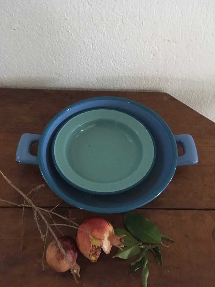Two matching enameled dishes in green and blue