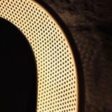 Luminous mirror in perforated sheet metal and brass