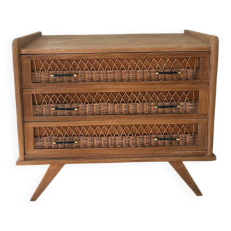 Vintage commode with tapered legs and rattan.