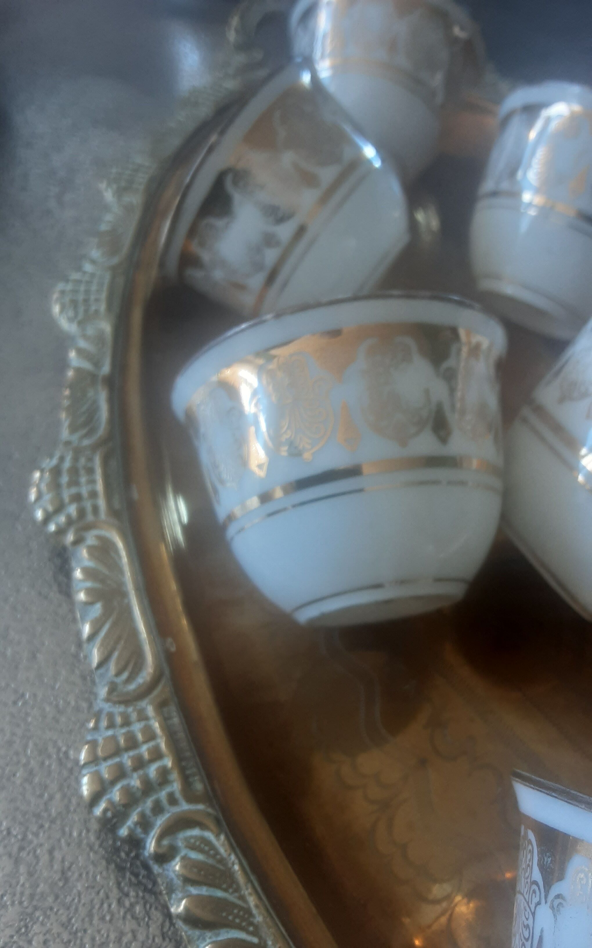Old service porcelain brass cups