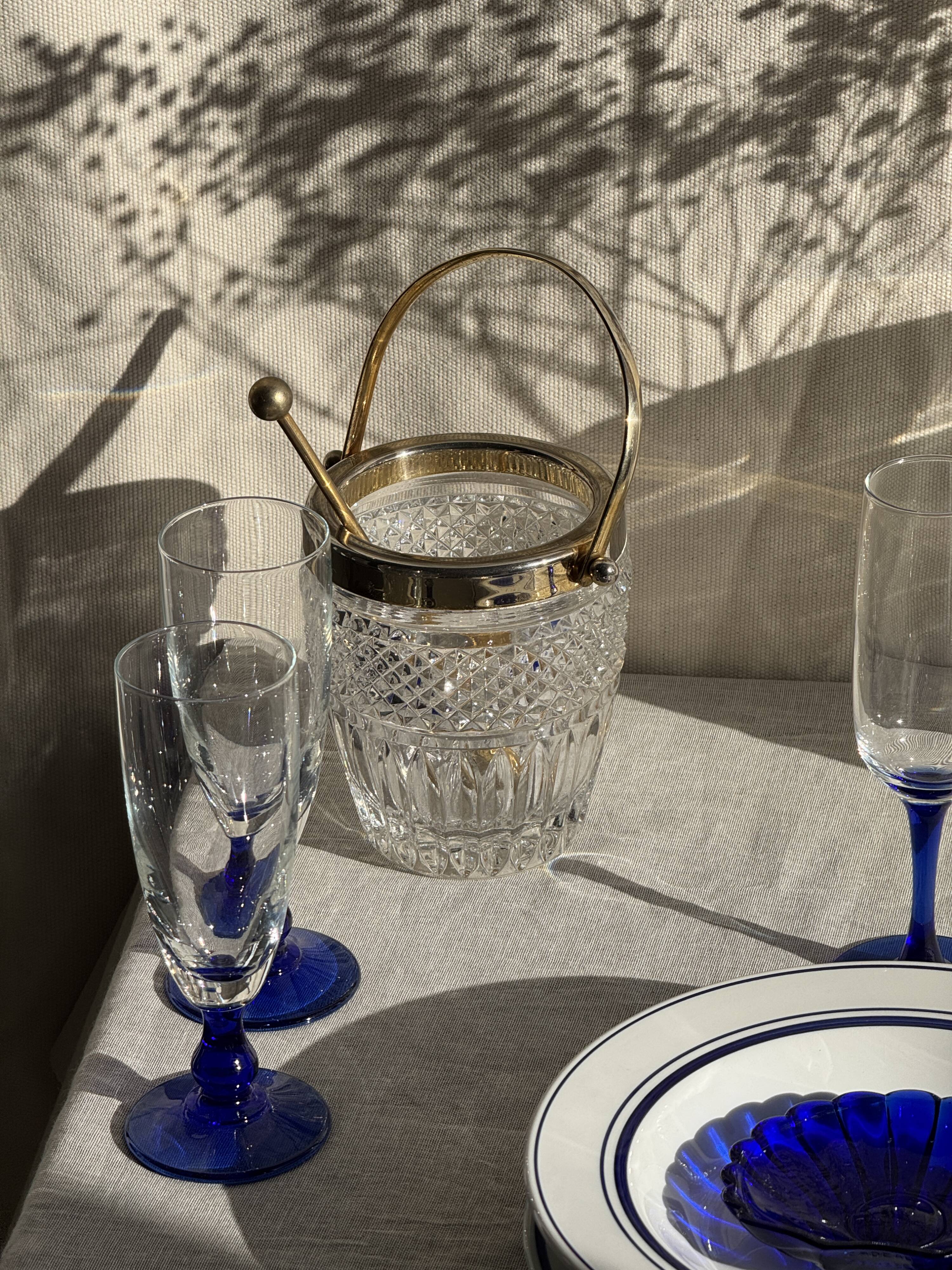 Small golden glass ice bucket with diamond point design and its scoop.
