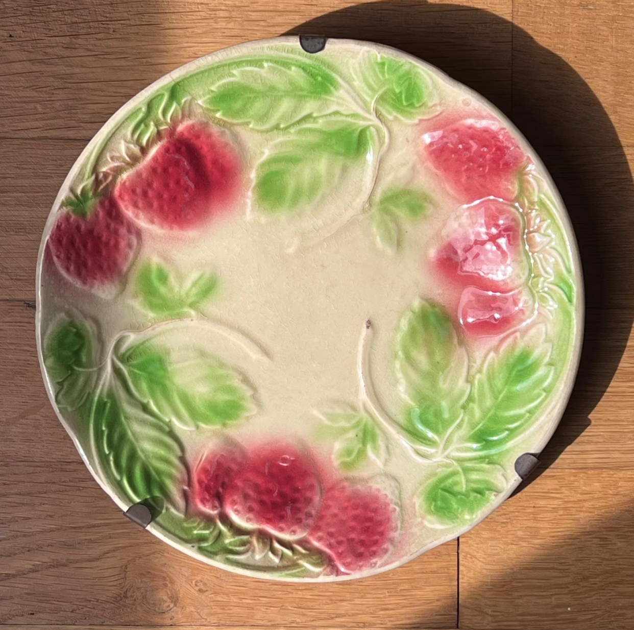 Plate in slip decoration strawberries and leaves