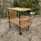 Vintage 1950s rolling dessert trolley in wicker and black tubing.