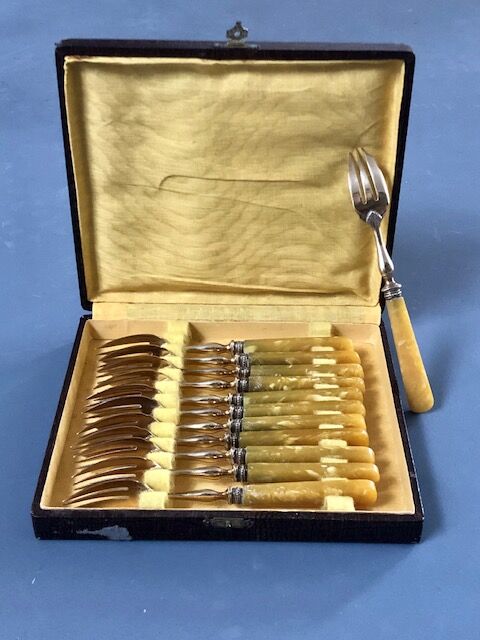 Brass and yellow galathite cake forks