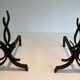 Pair of Wrought Iron Andirons with Stylised Flamboyant Uprights and Enrobed Feet