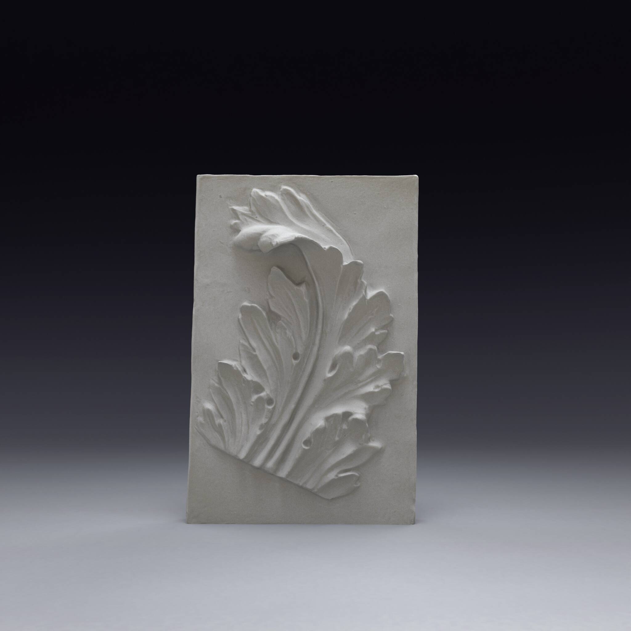 Plaster bas-relief depicting an acanthus leaf, inspired by Roman art.