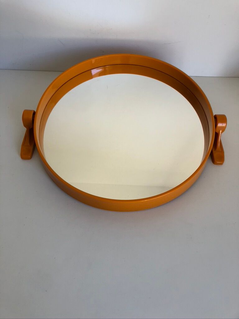 Tiltable orange plastic mirror with matching wall light