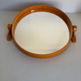 Tilting orange plastic mirror with its matching wall light