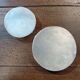 A pair of silver-plated bottle coasters for 75cl and 25cl.