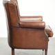 Subtle dark brown sheepskin wingback armchair with a timeless look subtle