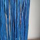 Table lamp in black stoneware and natural raffia.