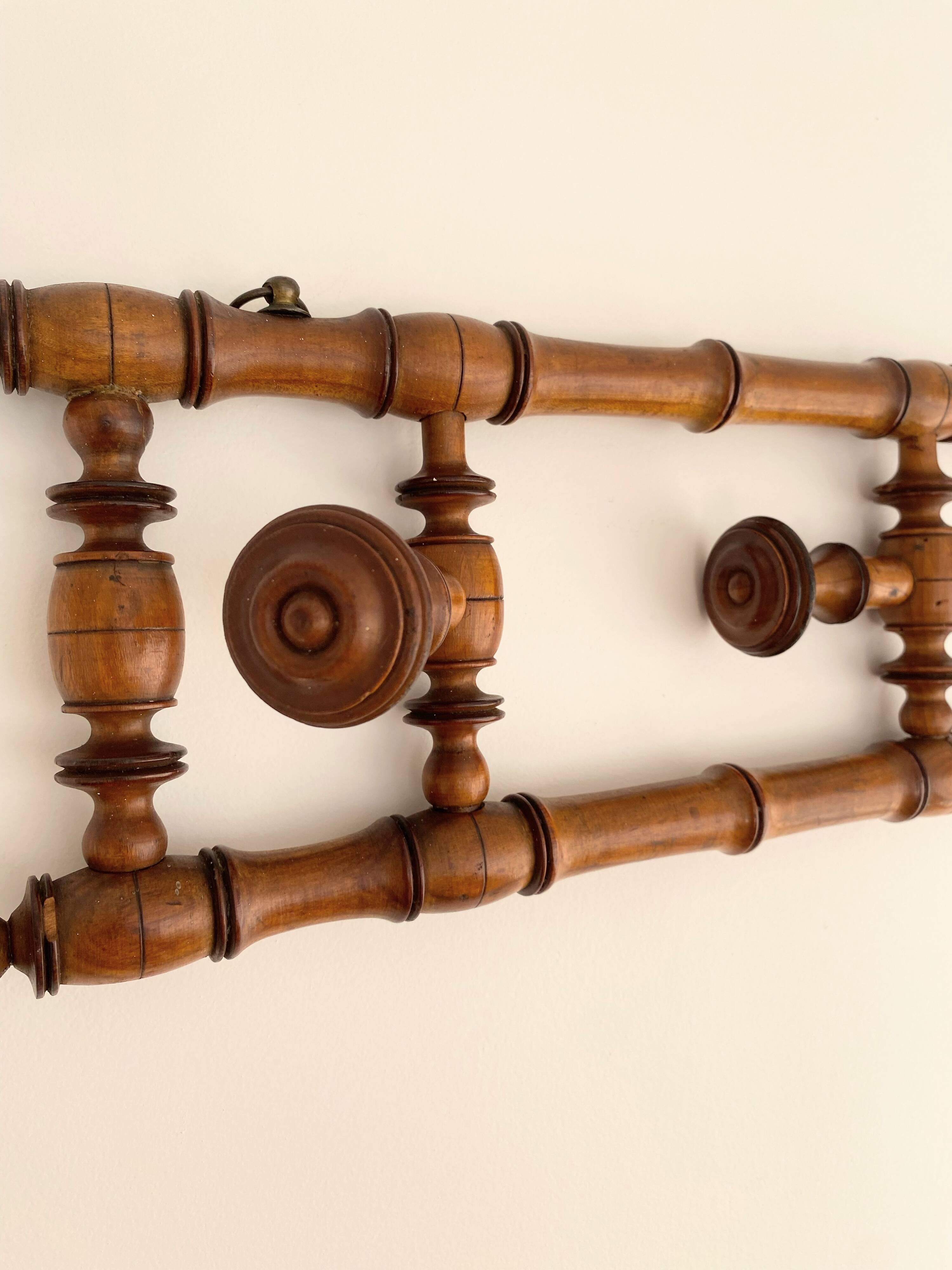 Vintage wooden wall coat rack with 4 swivel hooks from 1920