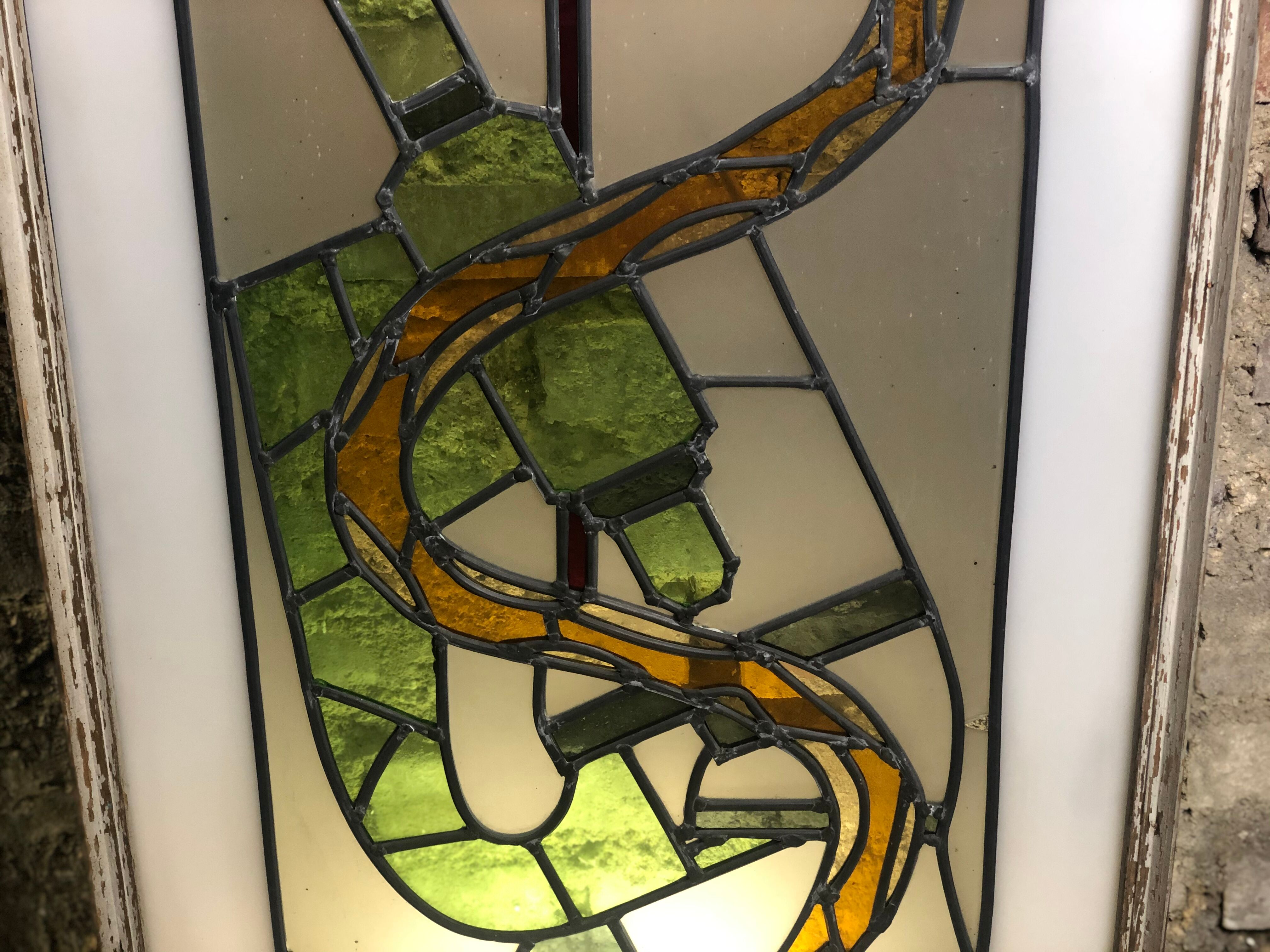 Old stained glass sign with deciduous decoration and microscope