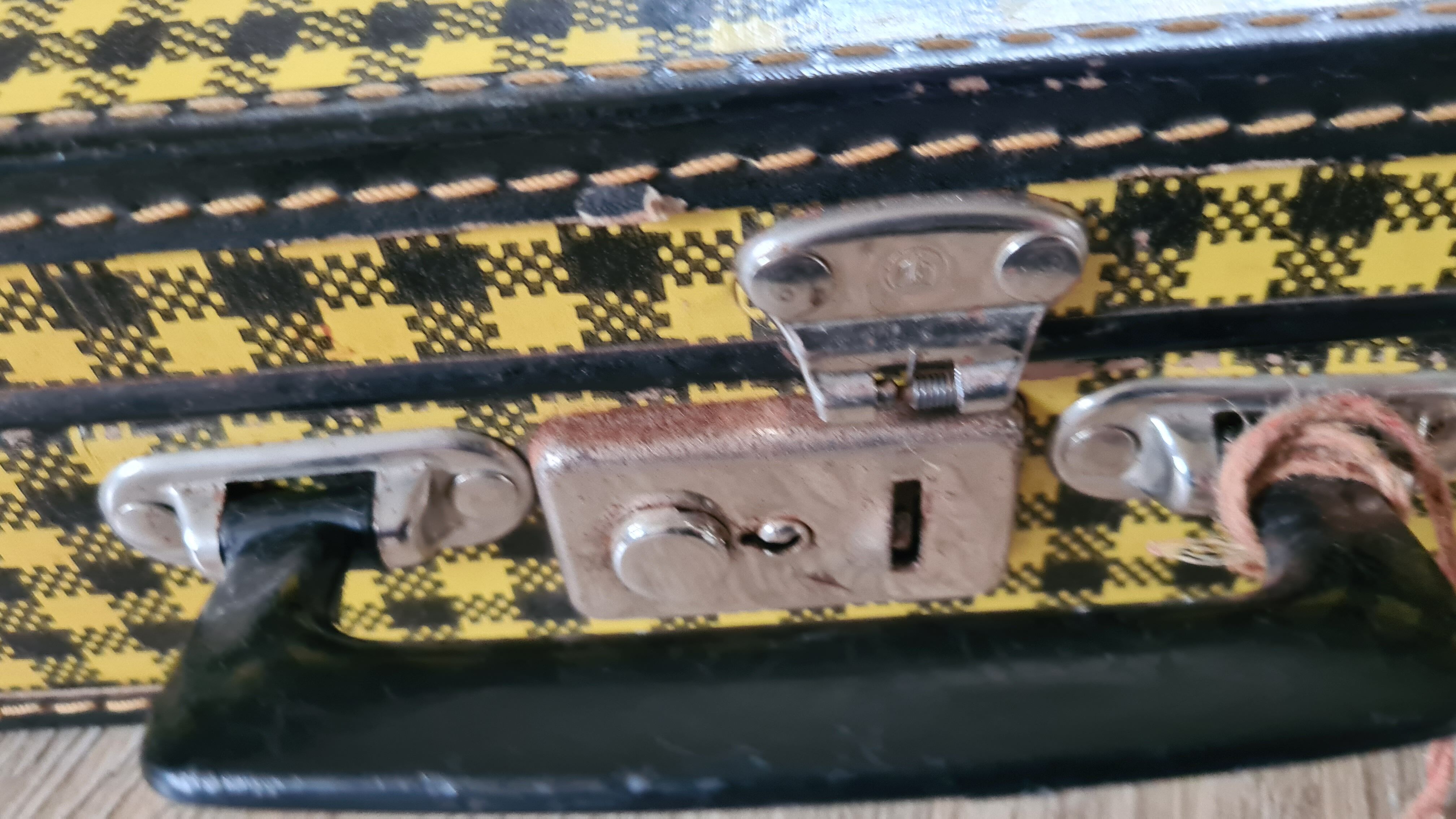 Antique suitcase in vintage yellow and black cardboard