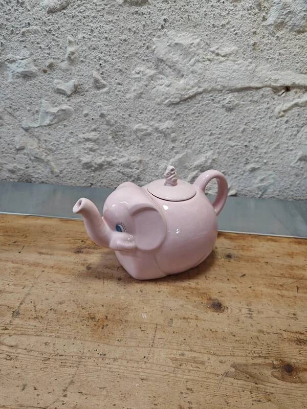 Antique pink elephant teapot in earthenware.