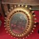 Golden metal sun mirror with leaf decoration