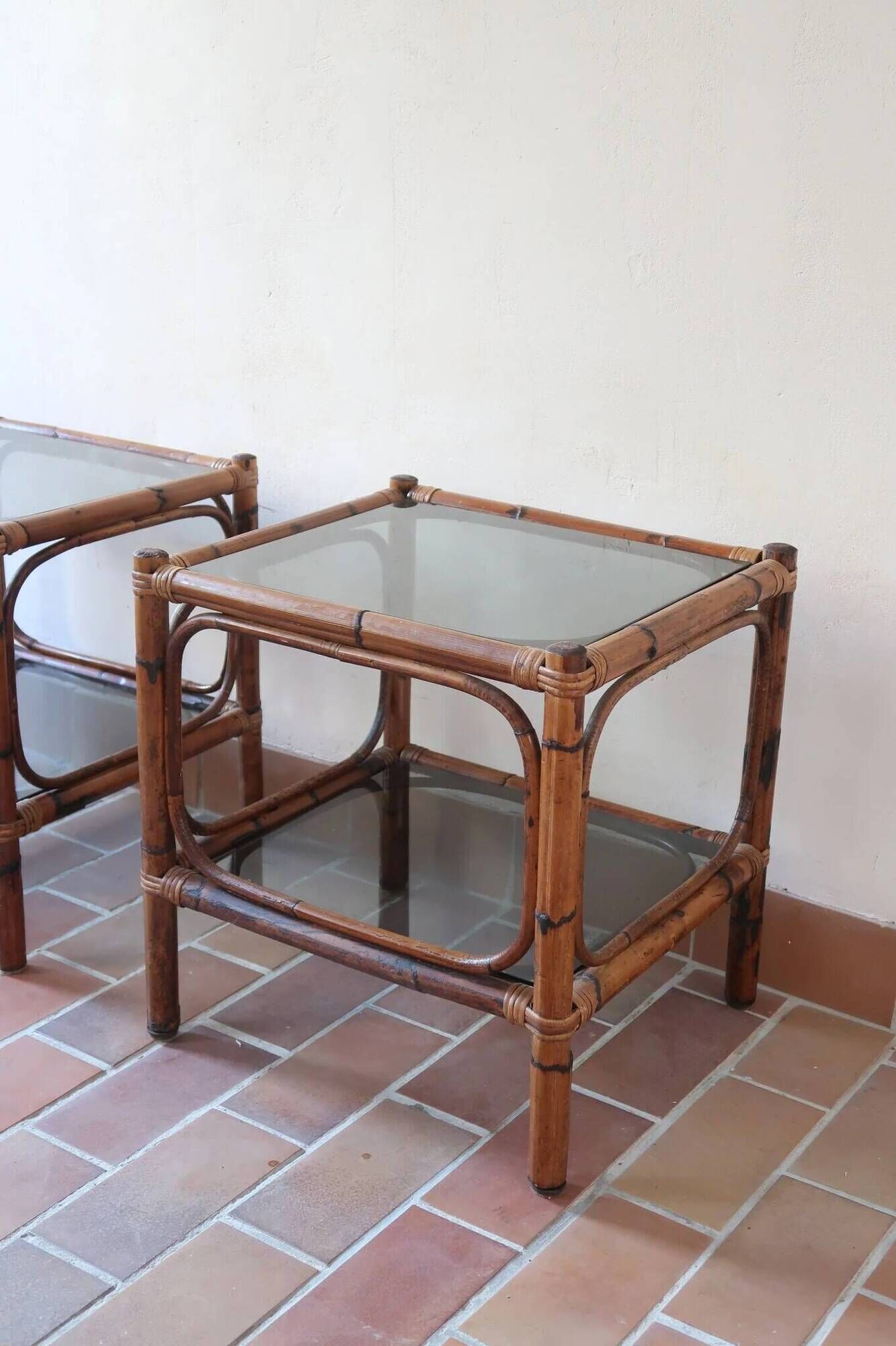Pair of bamboo and rattan bedside tables, smoked glass tops.