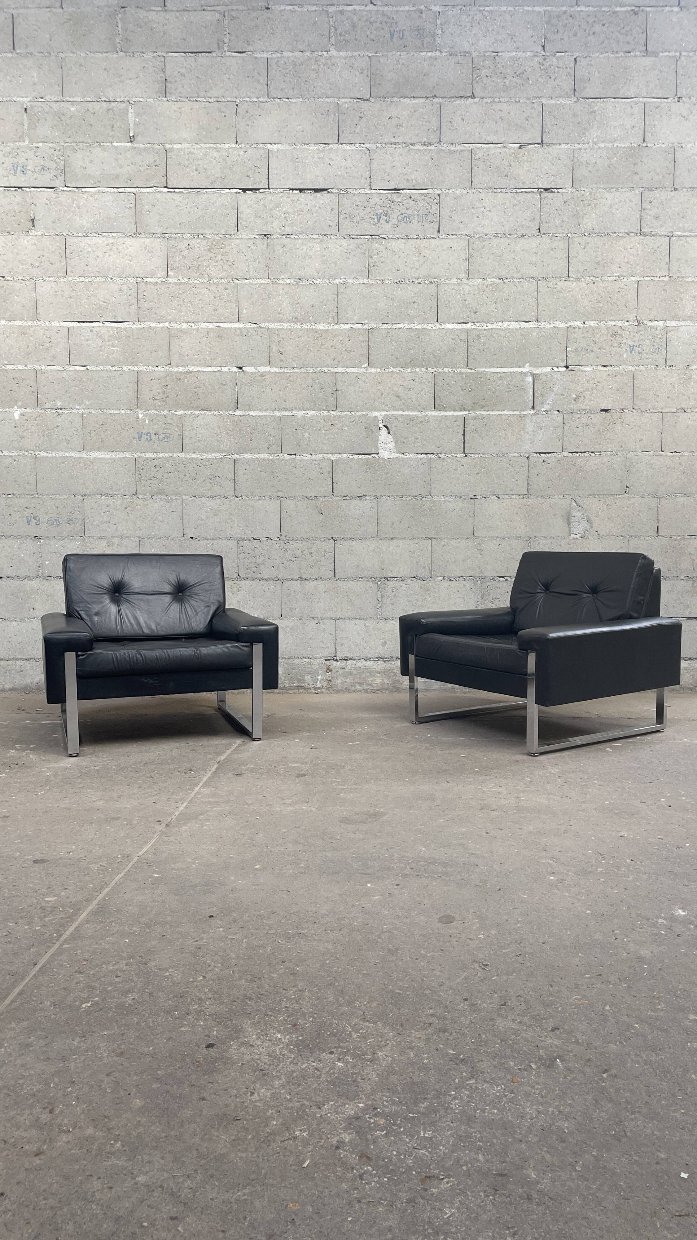 Pair of black leather armchairs