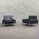 Pair of black leather armchairs