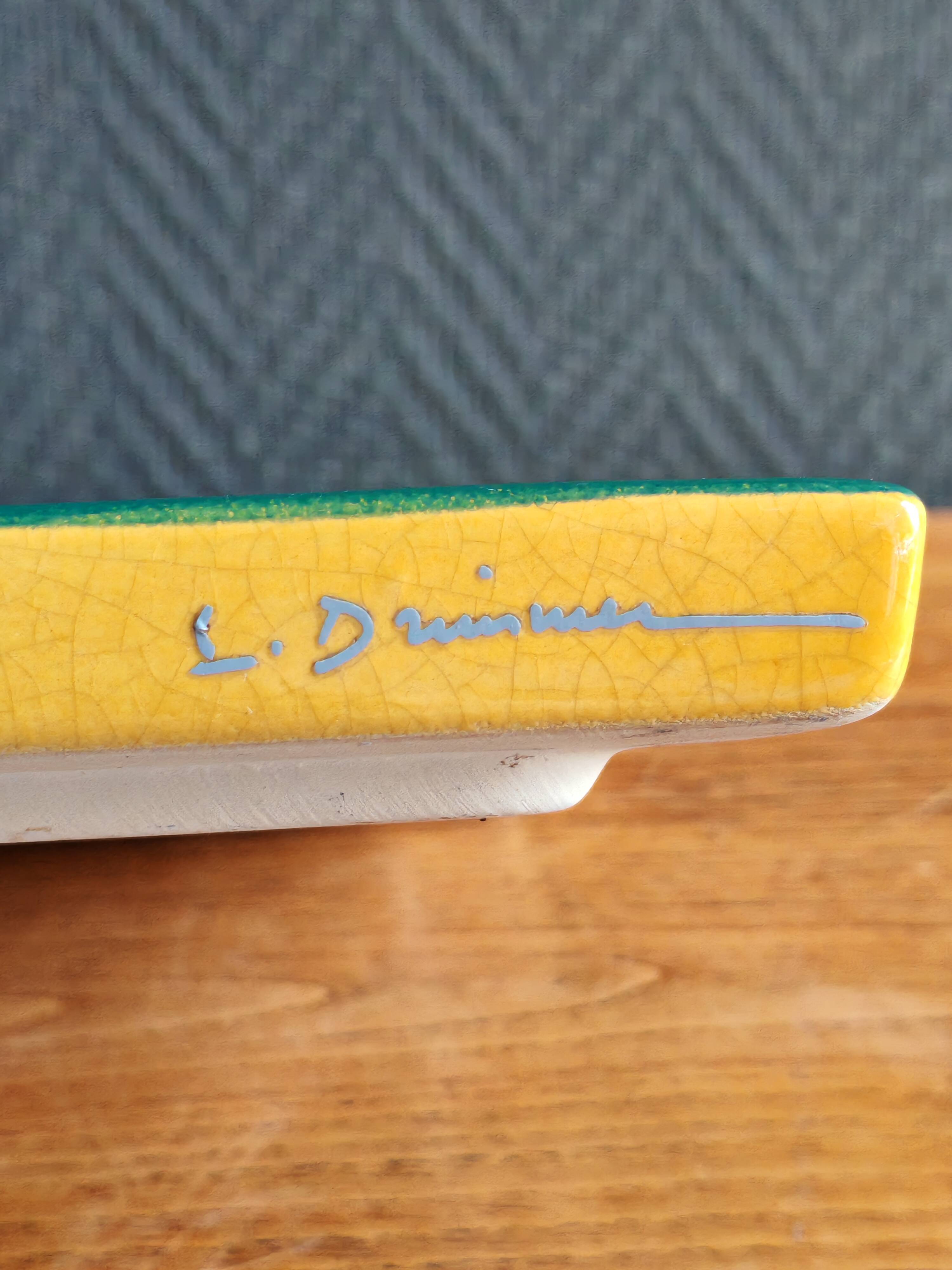 Yellow glazed ceramic trivet signed l. drimmer