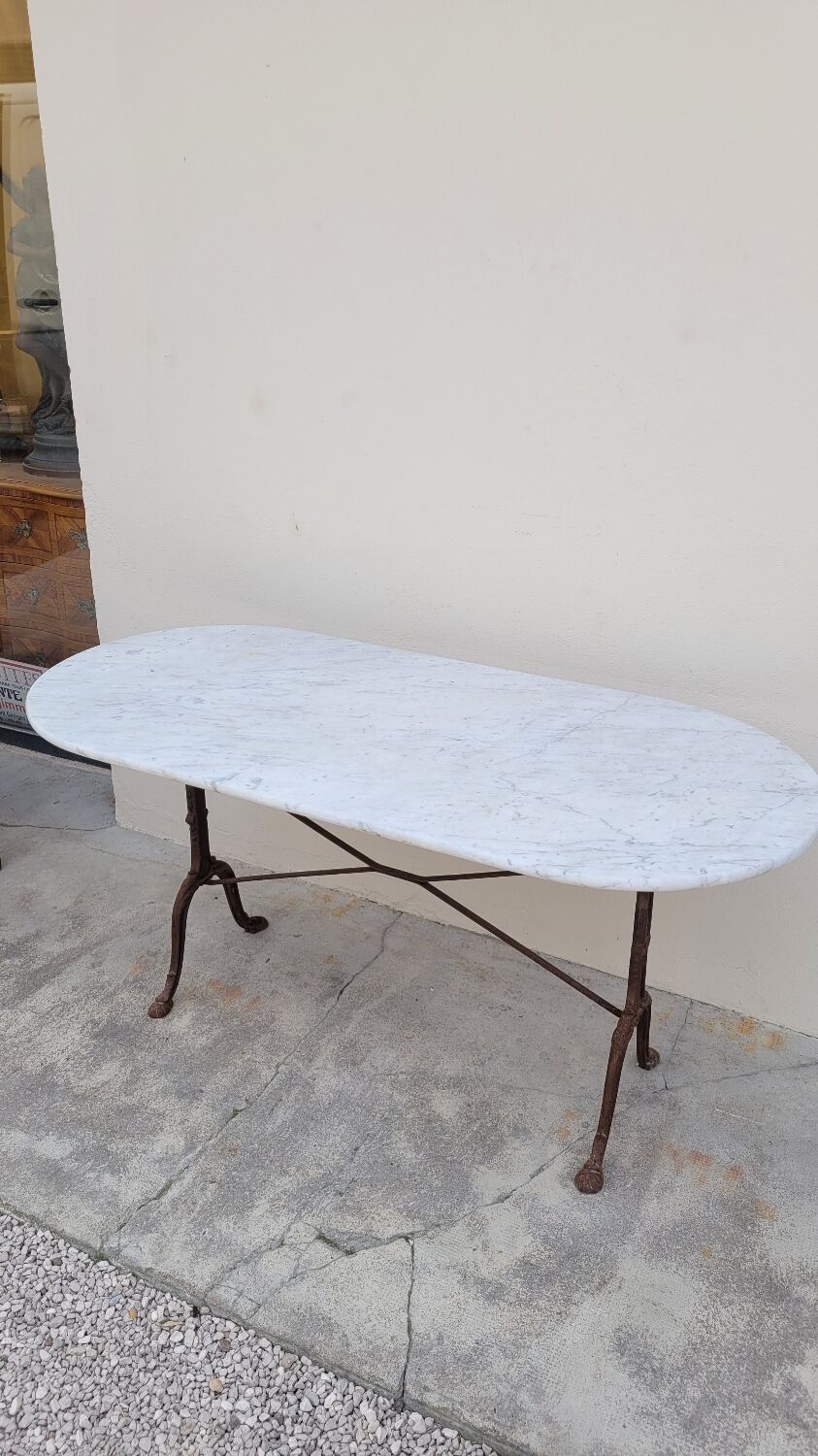 Restaurant bistro table in oval marble and decorated cast iron bases -1m51