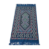 Blue carpet with multicolored patterns woven hands in natural wool