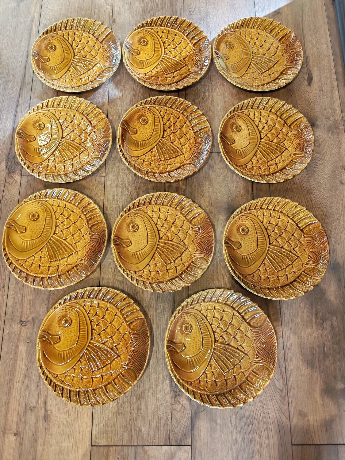 Vintage barbotine plates with fish decoration, 22 pieces.